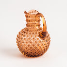 Hobnail Glass Pitcher in Honey Gold on a white background at Addison West
