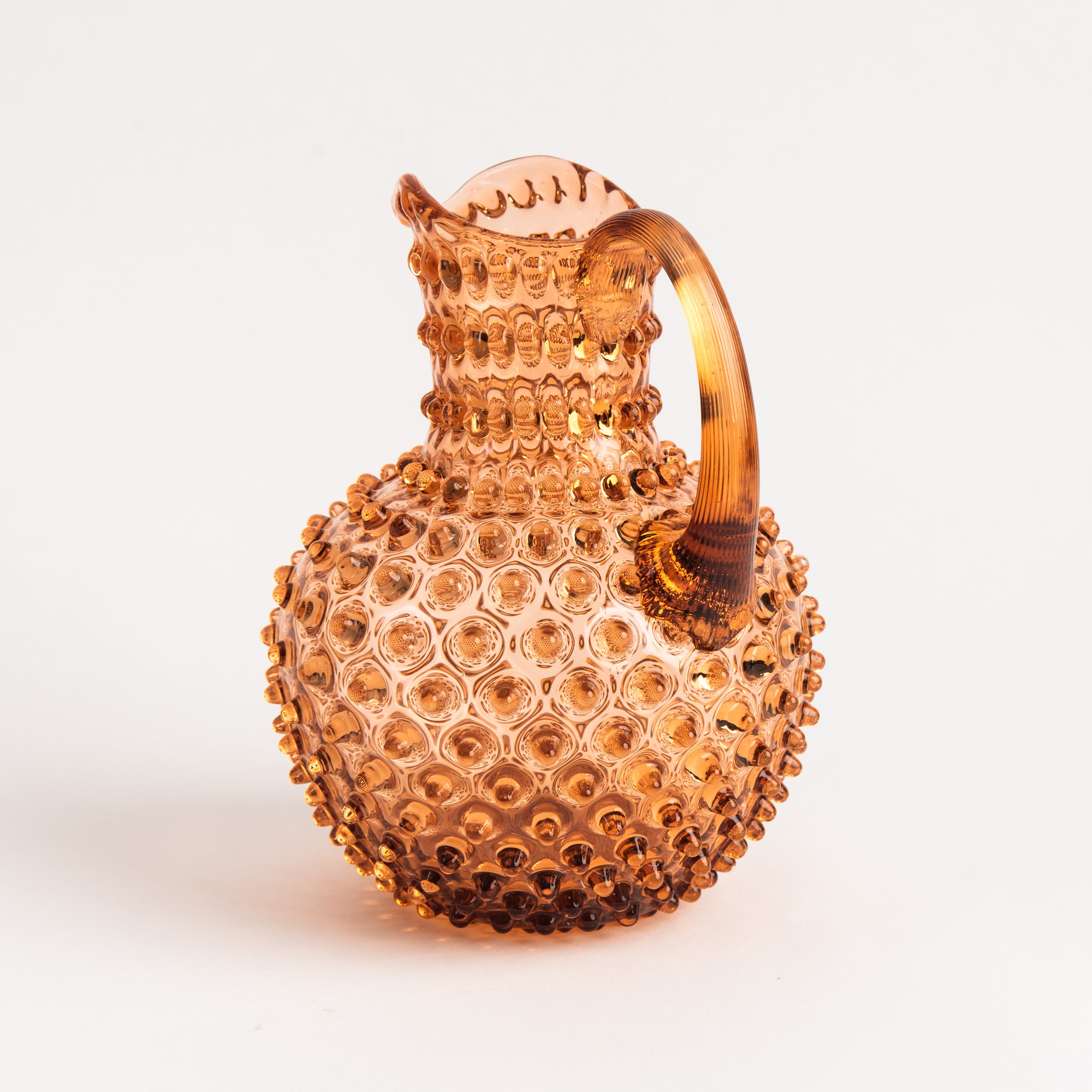 Hobnail Glass Pitcher in Honey Gold on a white background at Addison West