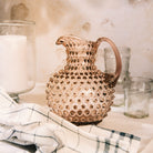 Hobnail Glass Pitcher in Night Iris on a table at Addison West