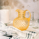 Hobnail Glass Pitcher, Limoncello on a table at Addison West