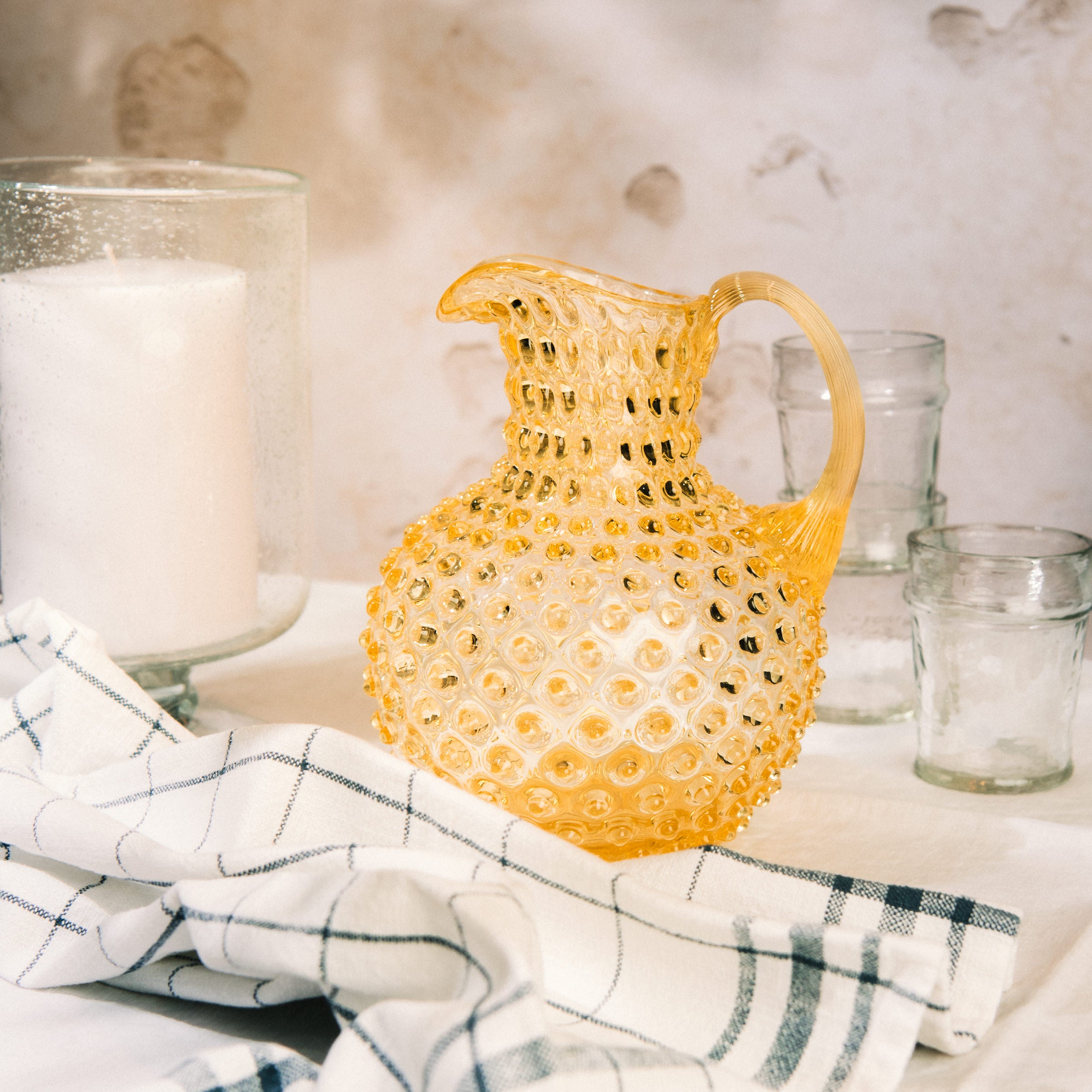 Hobnail Glass Pitcher, Limoncello on a table at Addison West