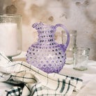 Hobnail Glass Pitcher in Lilac Bloom on a table at Addison West