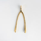 Large Gold Wishbone on a white background at Addison West