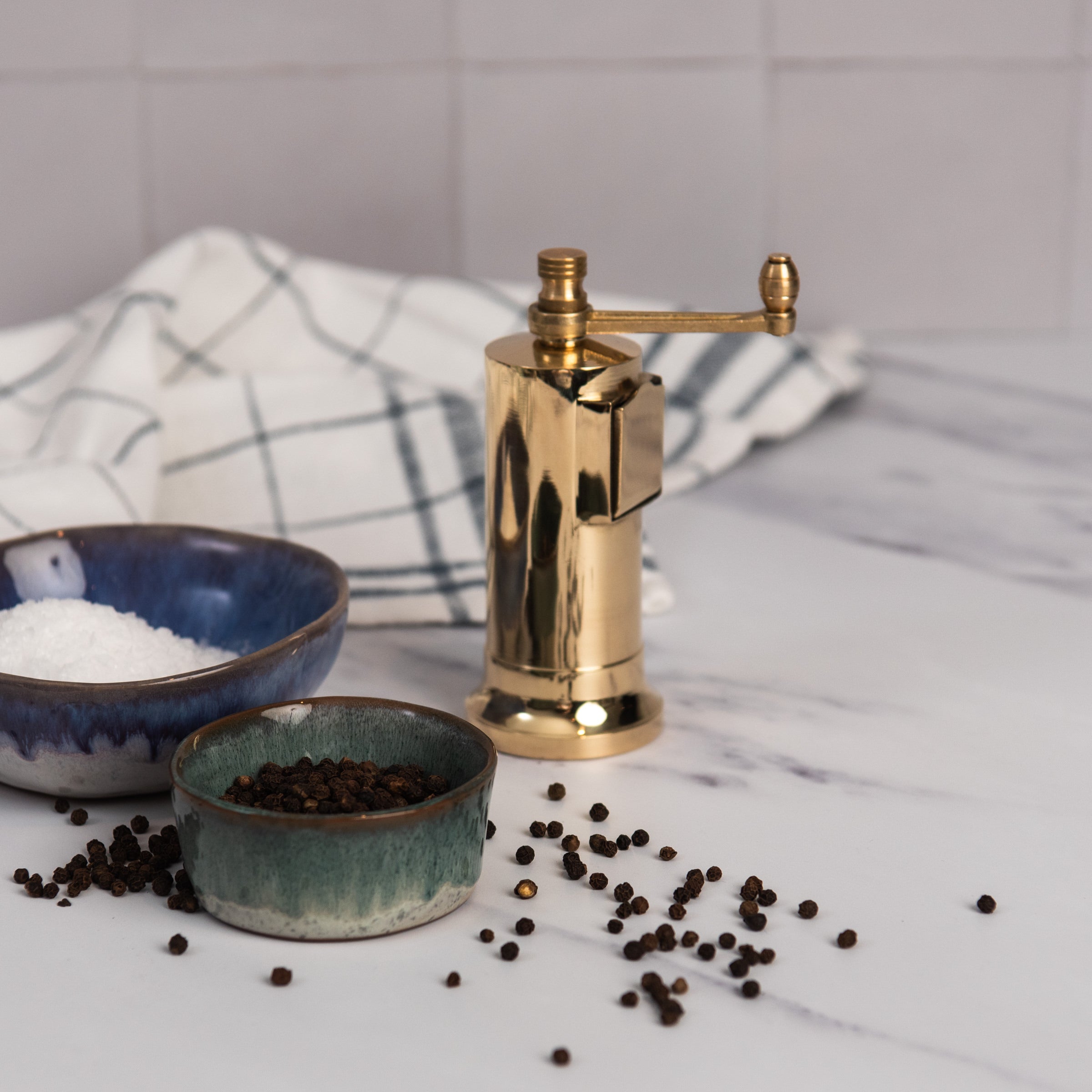 Alexander Brass Chefs' Mate Pepper Grinder on a kitchen counter at Addison West