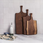 18" Black Walnut Serving Board on a kitchen counter at Addison West