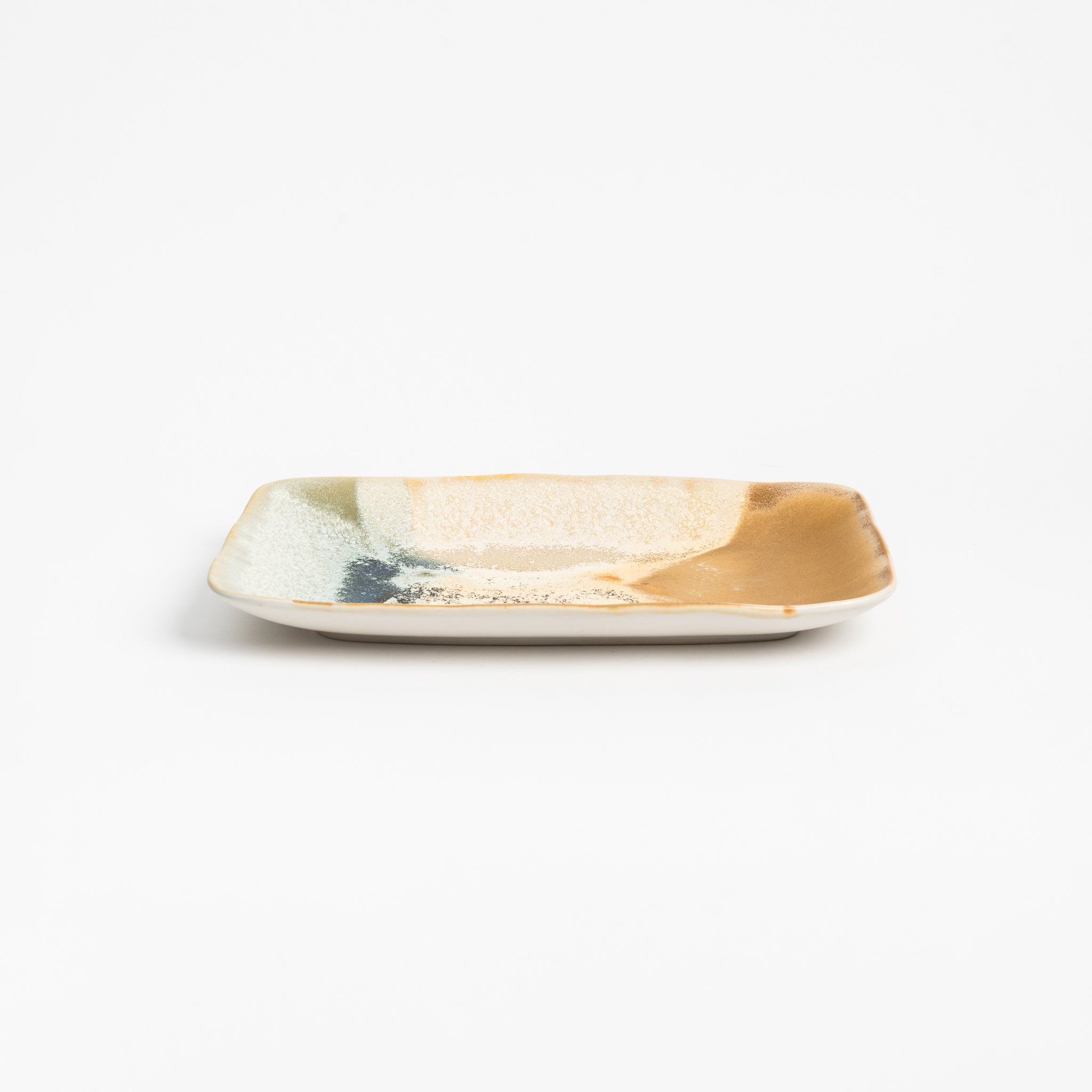 Serving platter with brown and blue reactive glaze. 