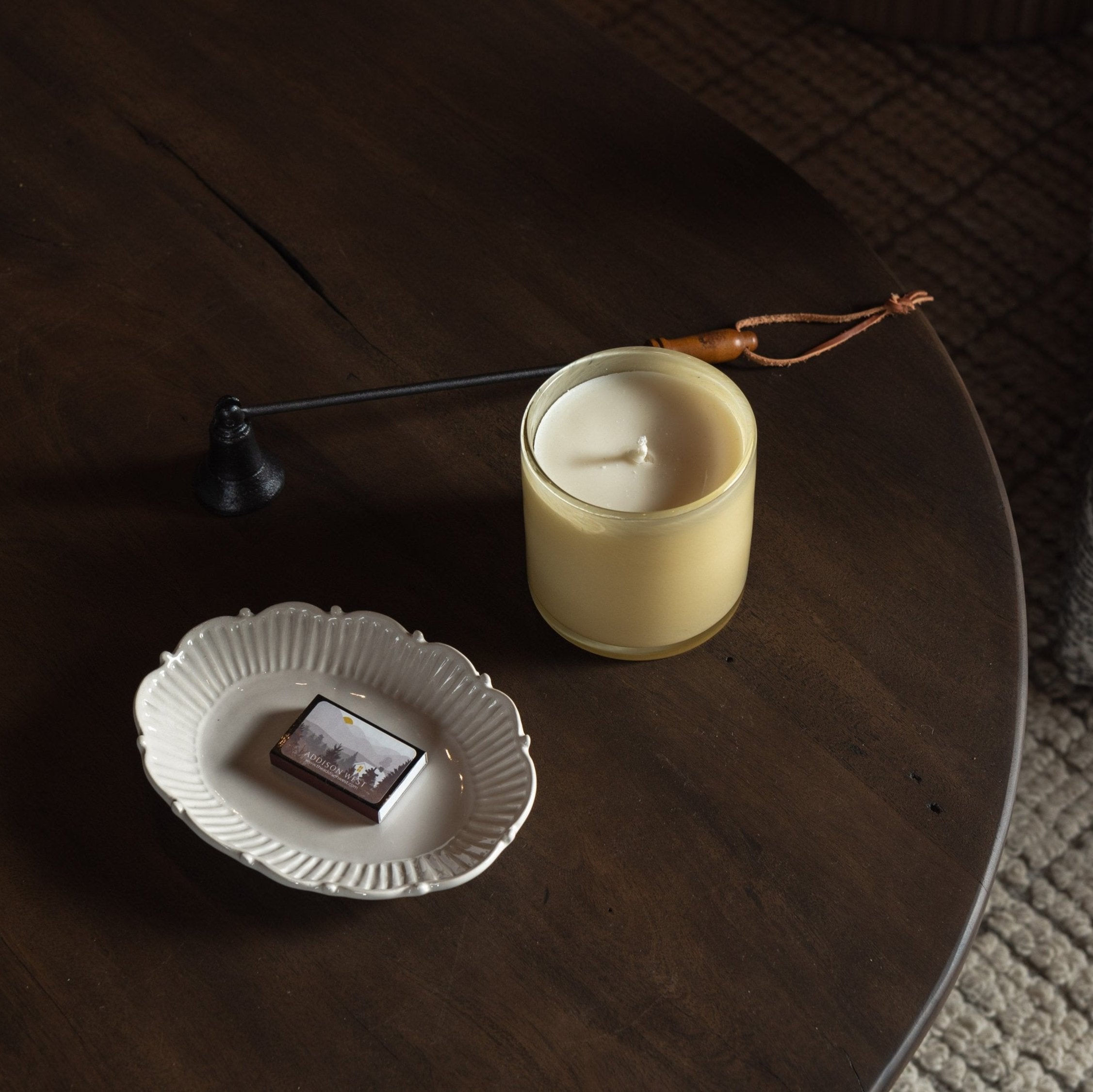 Lafco Chamomile Lavender Signature Candle on a dark wood table with accessories at Addison West