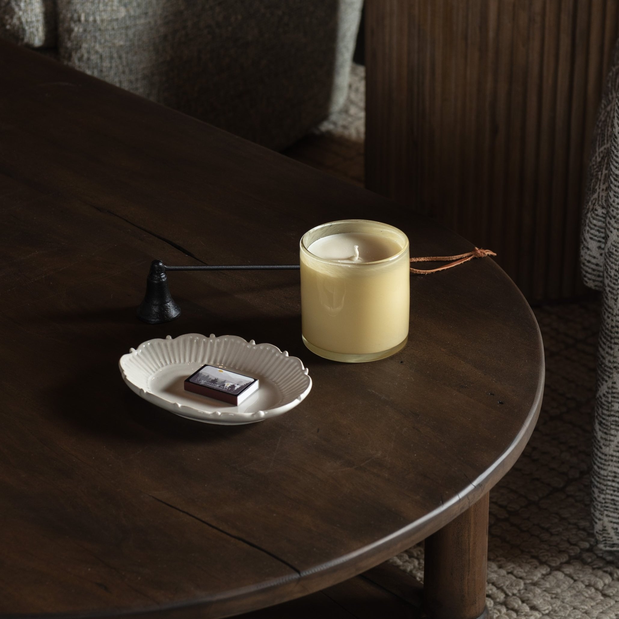 Lafco Chamomile Lavender Signature Candle on a dark wood table with accessories at Addison West