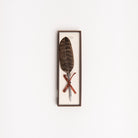 Feather pen on a white background at Addison West
