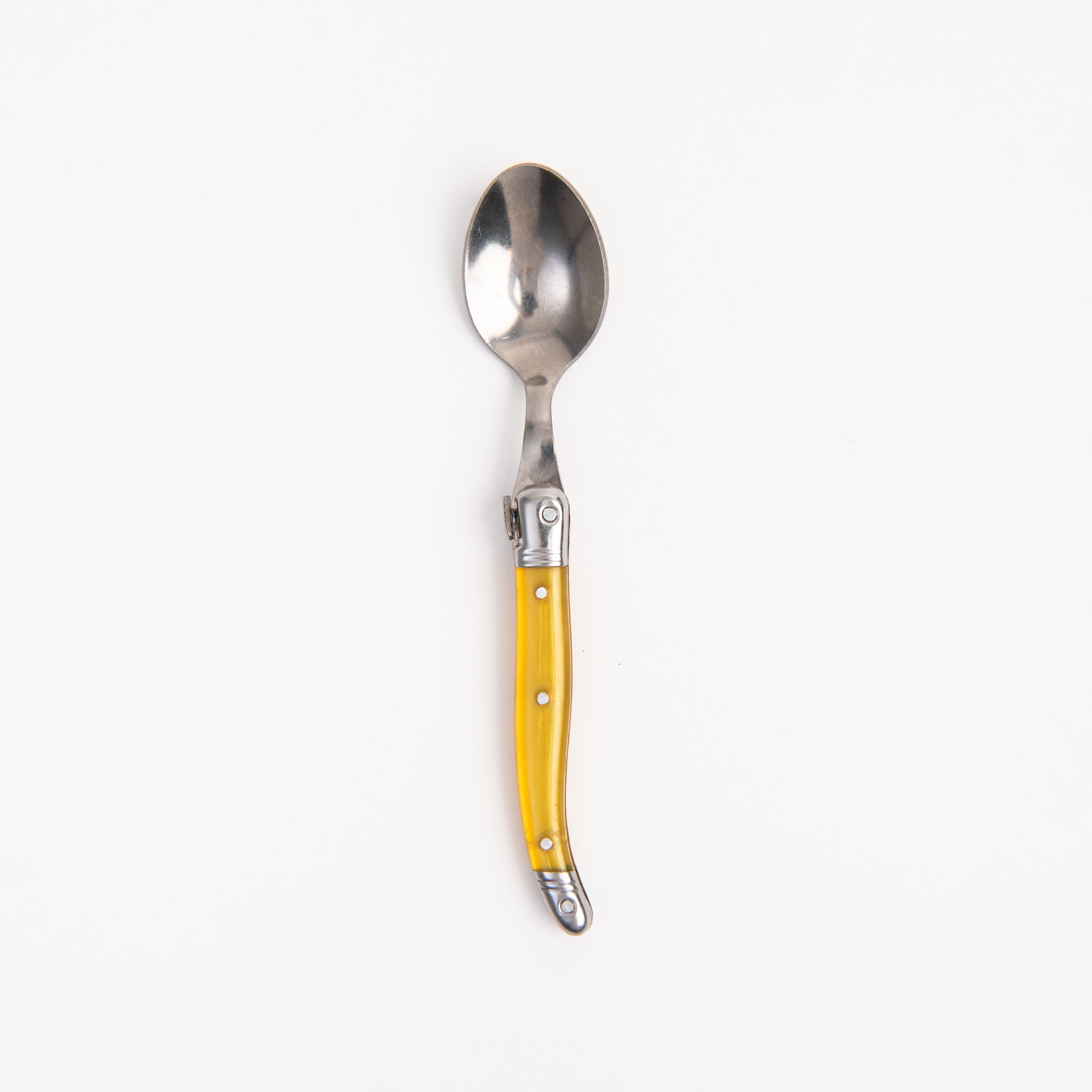 Laguiole Rainbow Spoon yello on a white background at Addison West