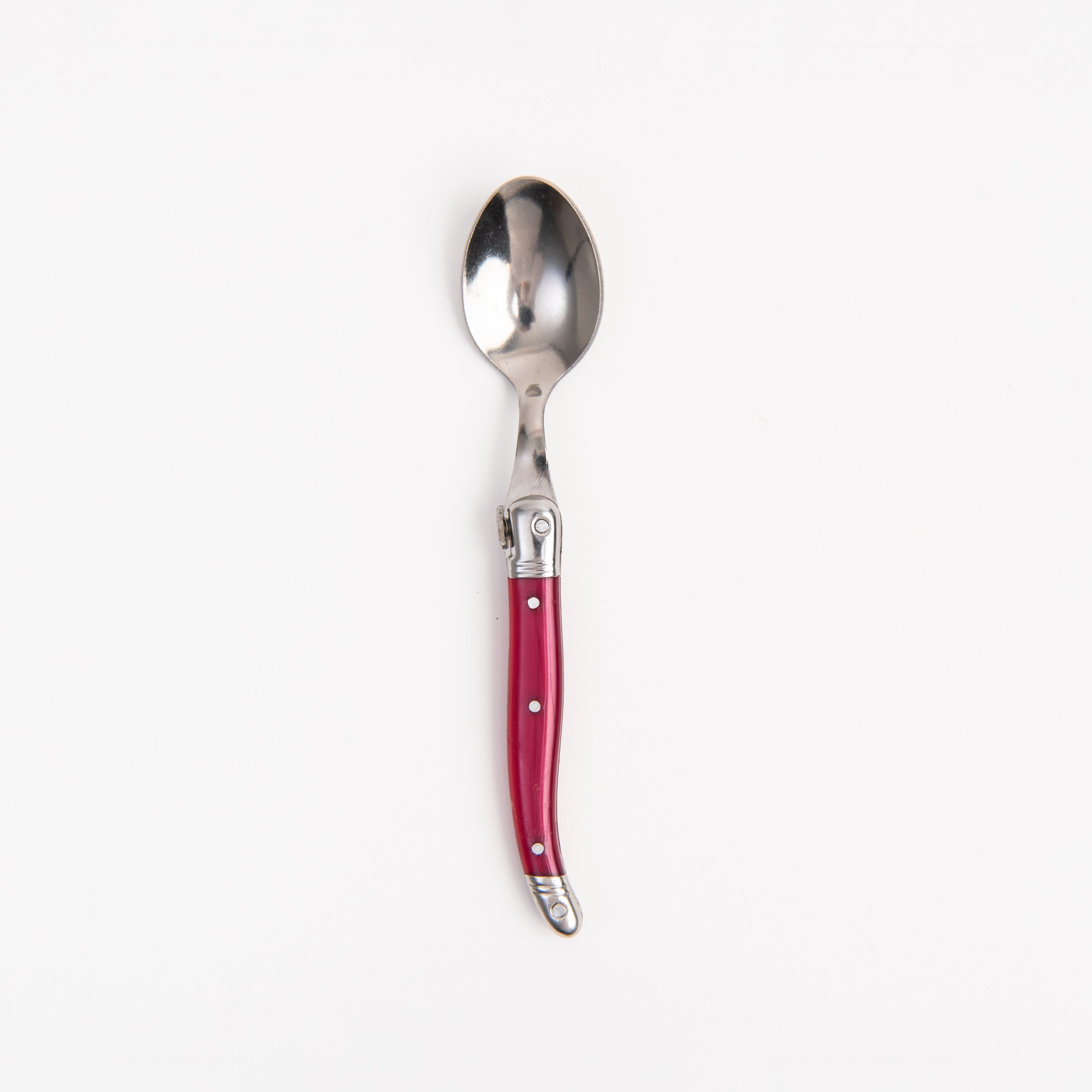 Laguiole Rainbow Spoon Cranberry on a white background at Addison West