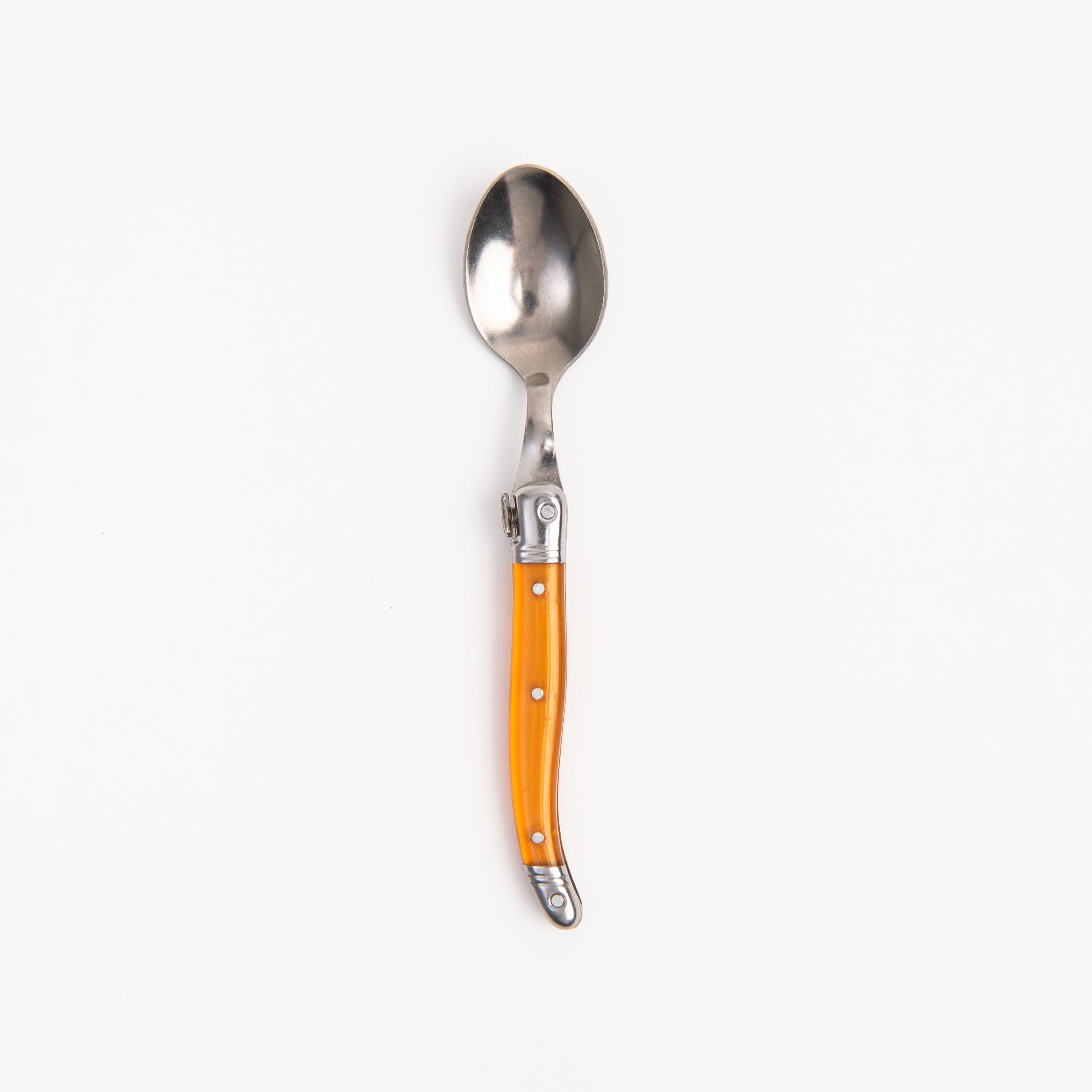 Laguiole Rainbow Spoon orange on a white background at Addison West