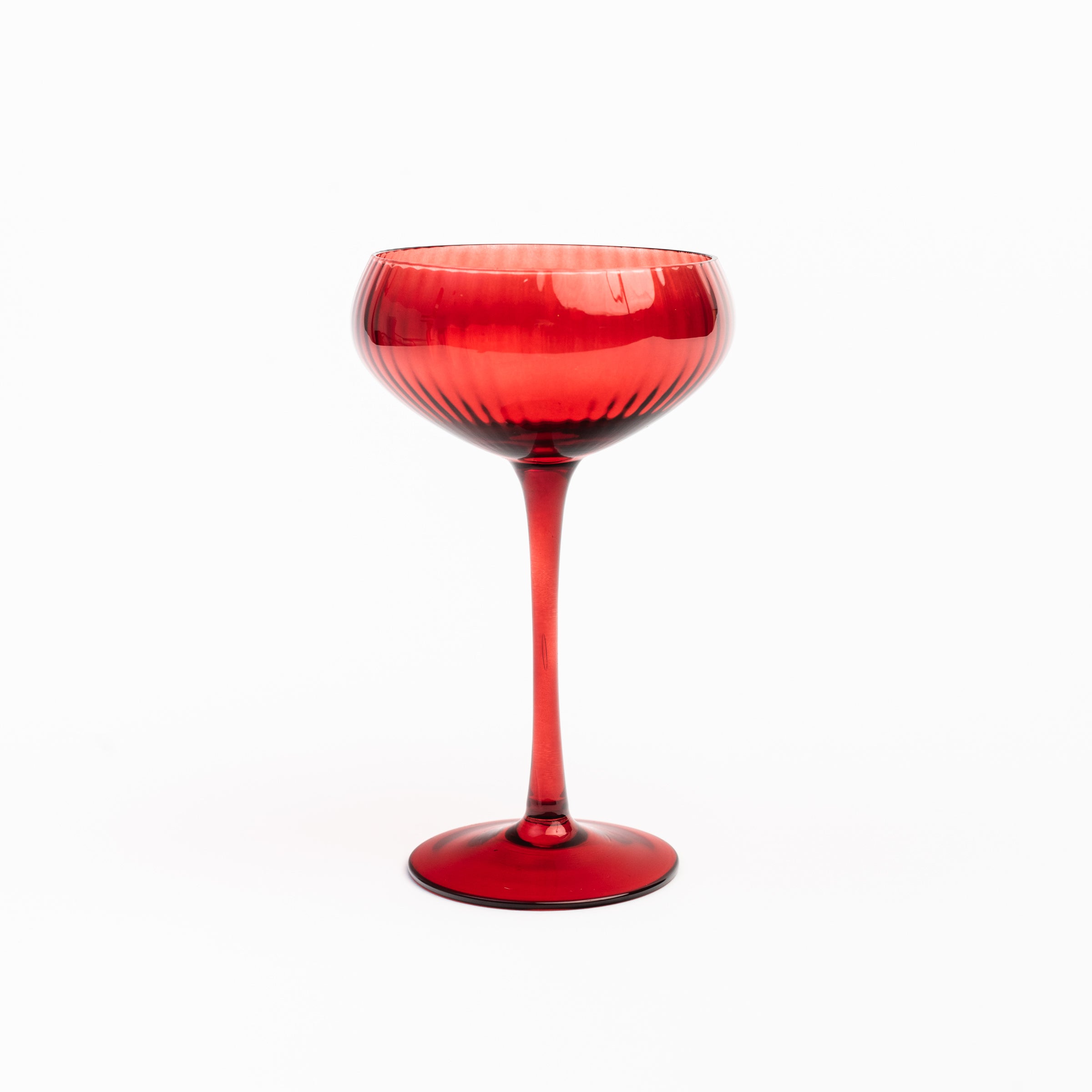 Cheers to You in Red champagne glass on a white background at Addison West