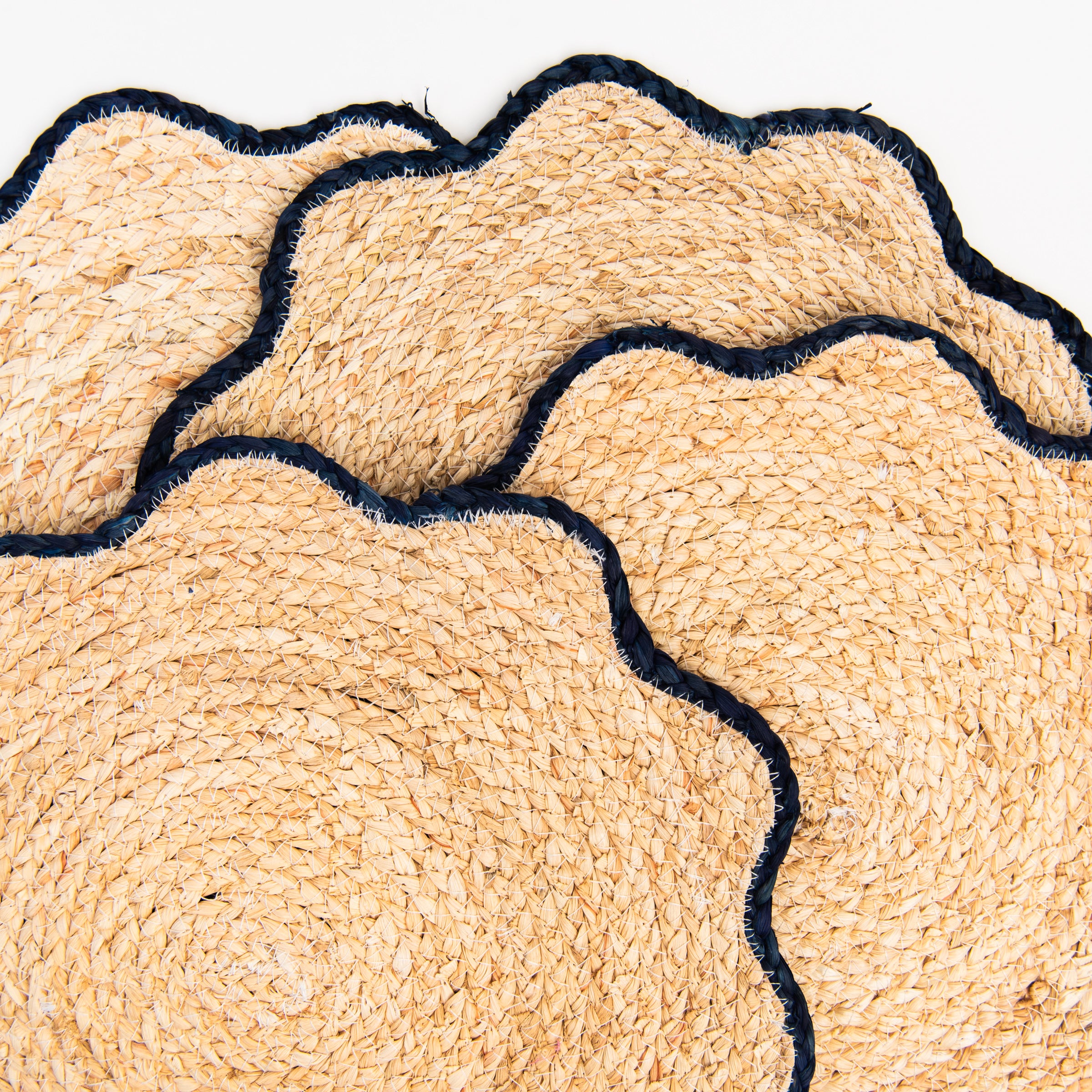 Close up of Handwoven Scalloped Edge Placemats on a white background at Addison West