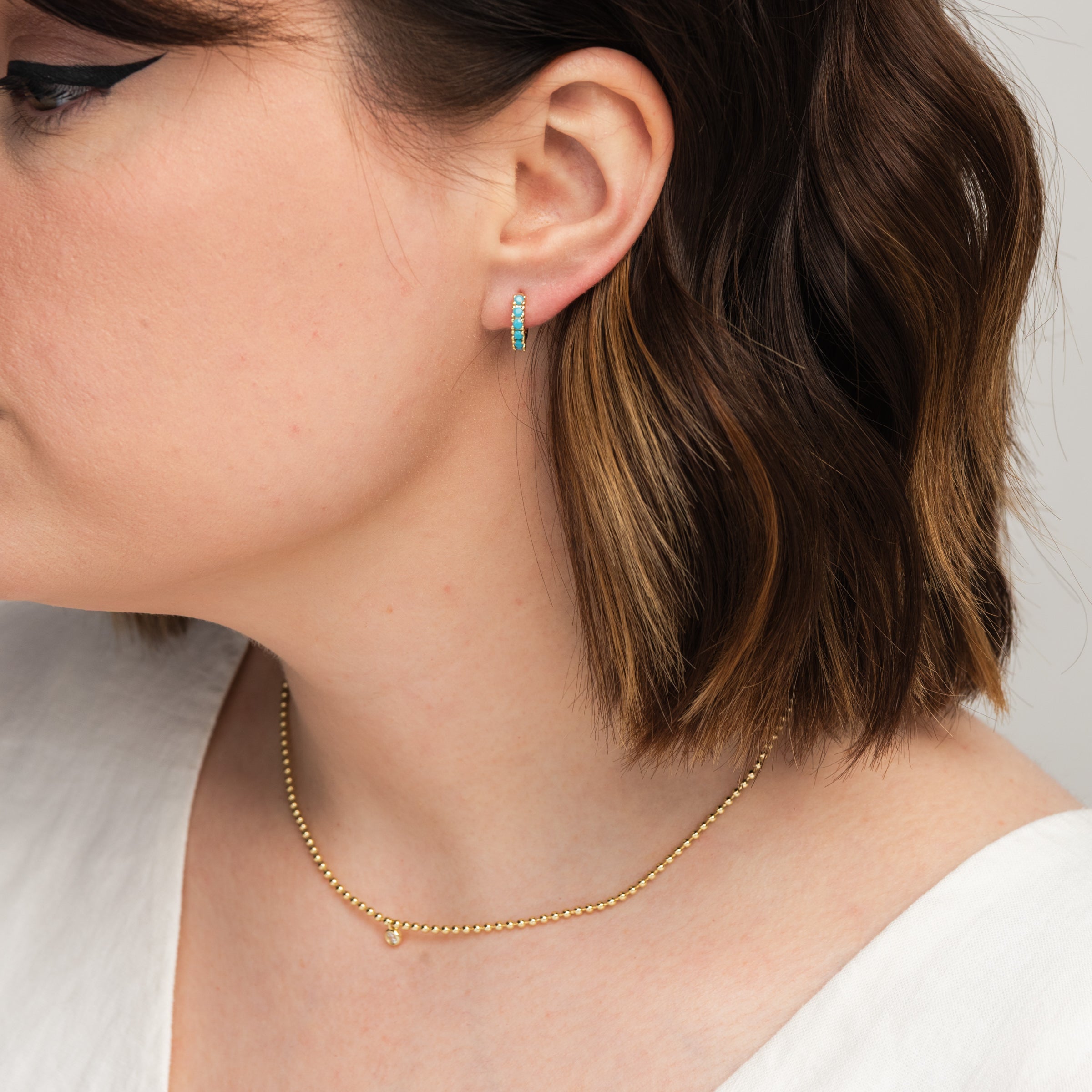 Elena Turquoise Huggies in Gold on a model at Addison West