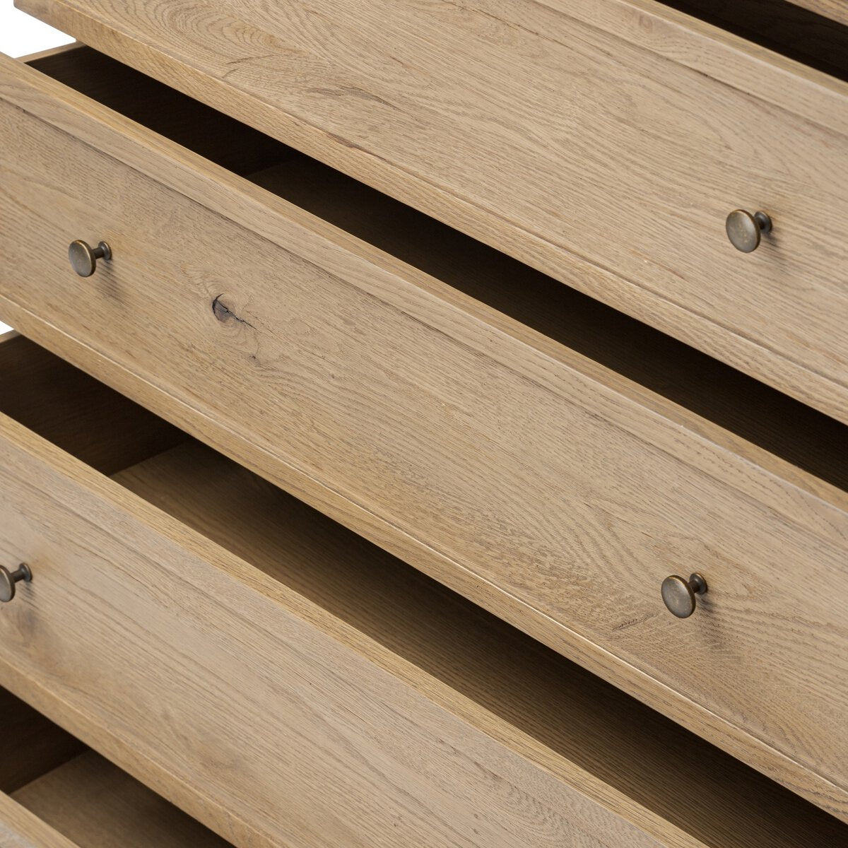 Close up of Amber Lewis x Four Hands Geoffrey Tall Dresser in Worn Oak Veneer on a white background at Addison West