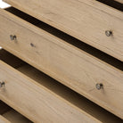 Close up of Amber Lewis x Four Hands Geoffrey Tall Dresser in Worn Oak Veneer on a white background at Addison West