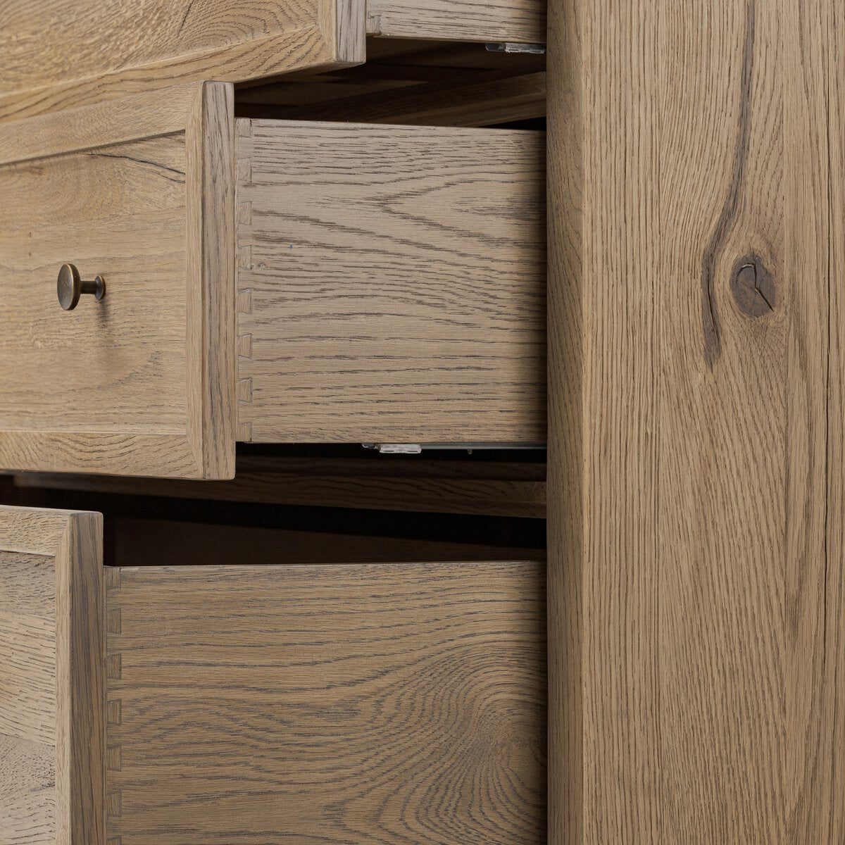 Close up of Amber Lewis x Four Hands Geoffrey Tall Dresser in Worn Oak Veneer on a white background at Addison West