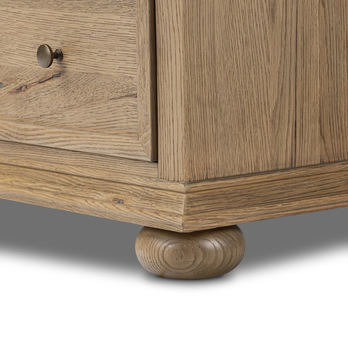 Close up of Amber Lewis x Four Hands Geoffrey Tall Dresser in Worn Oak Veneer on a white background at Addison West