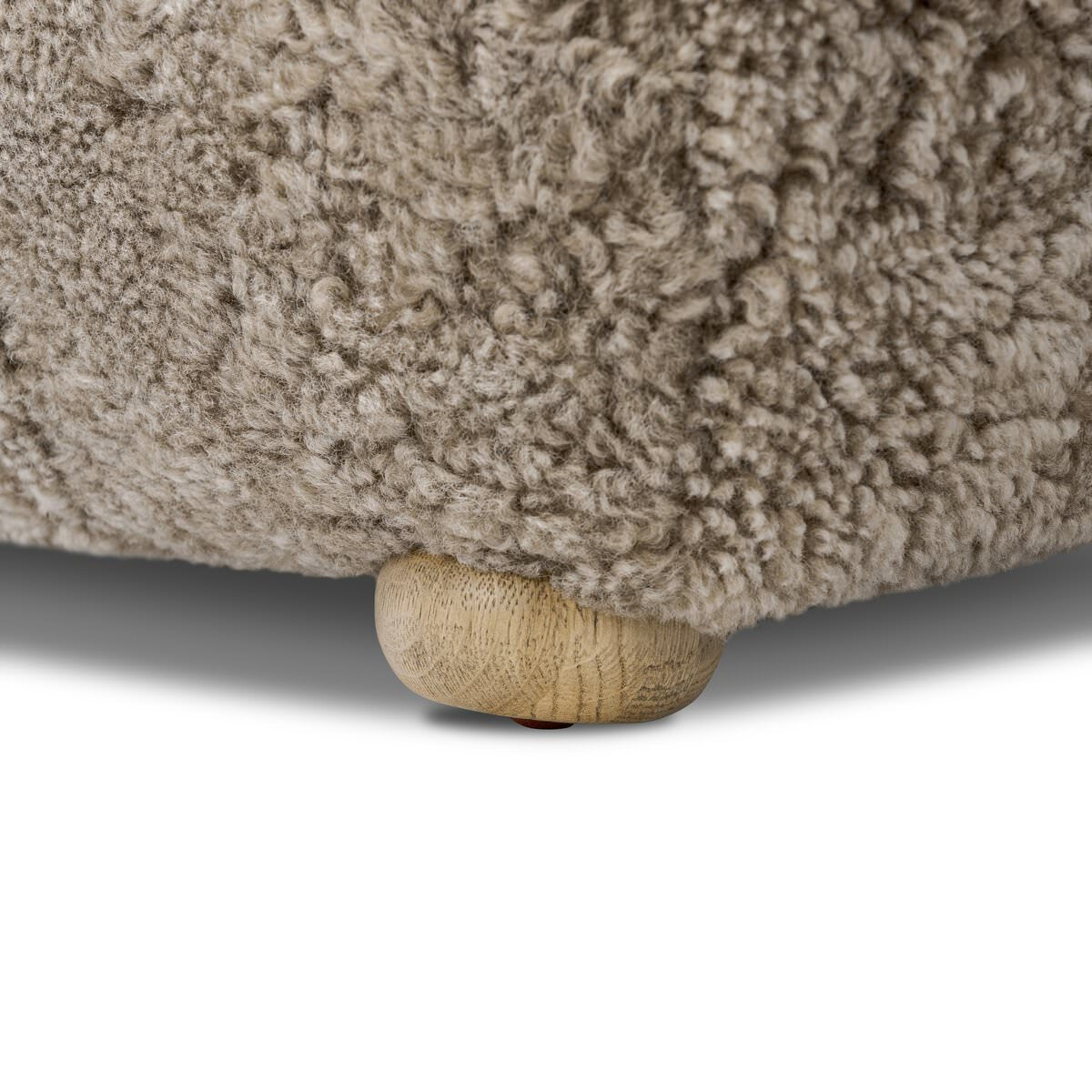 Close up of Amber Lewis x Four Hands Oslo Ottoman in Taupe Shearling on a white background at Addison West