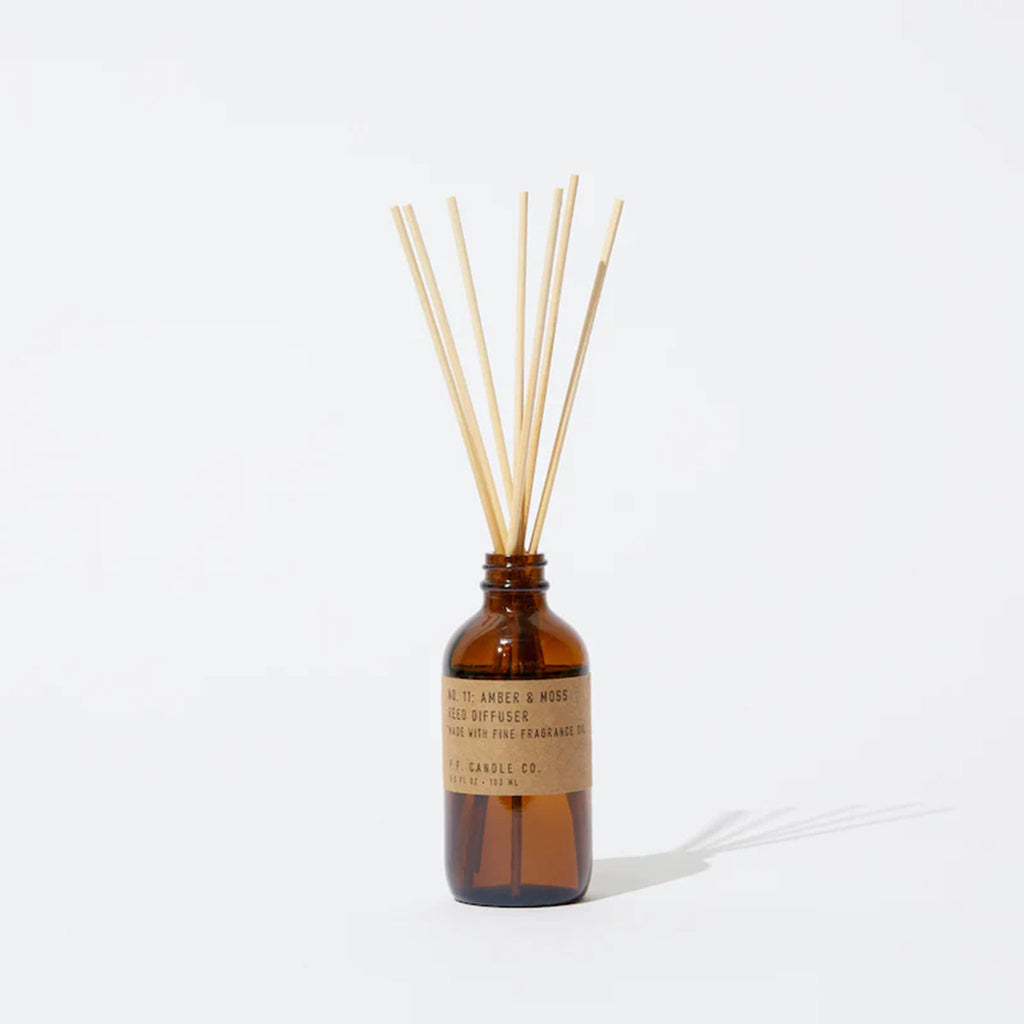 PF Candle Amber and Moss Reed Diffuser in brown glass jar on a white background