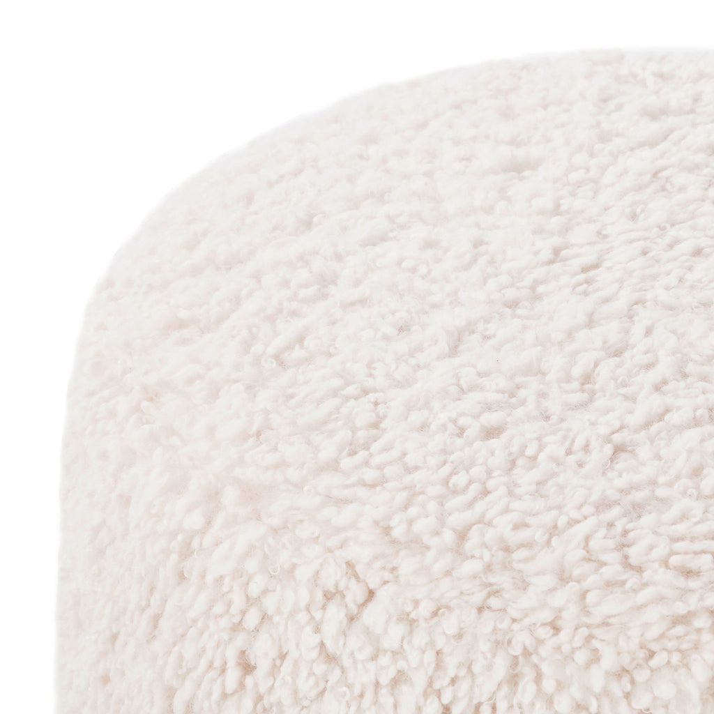 Close up of Four hands brand Aniston ottoman in natural shearling style upholstery on a white background