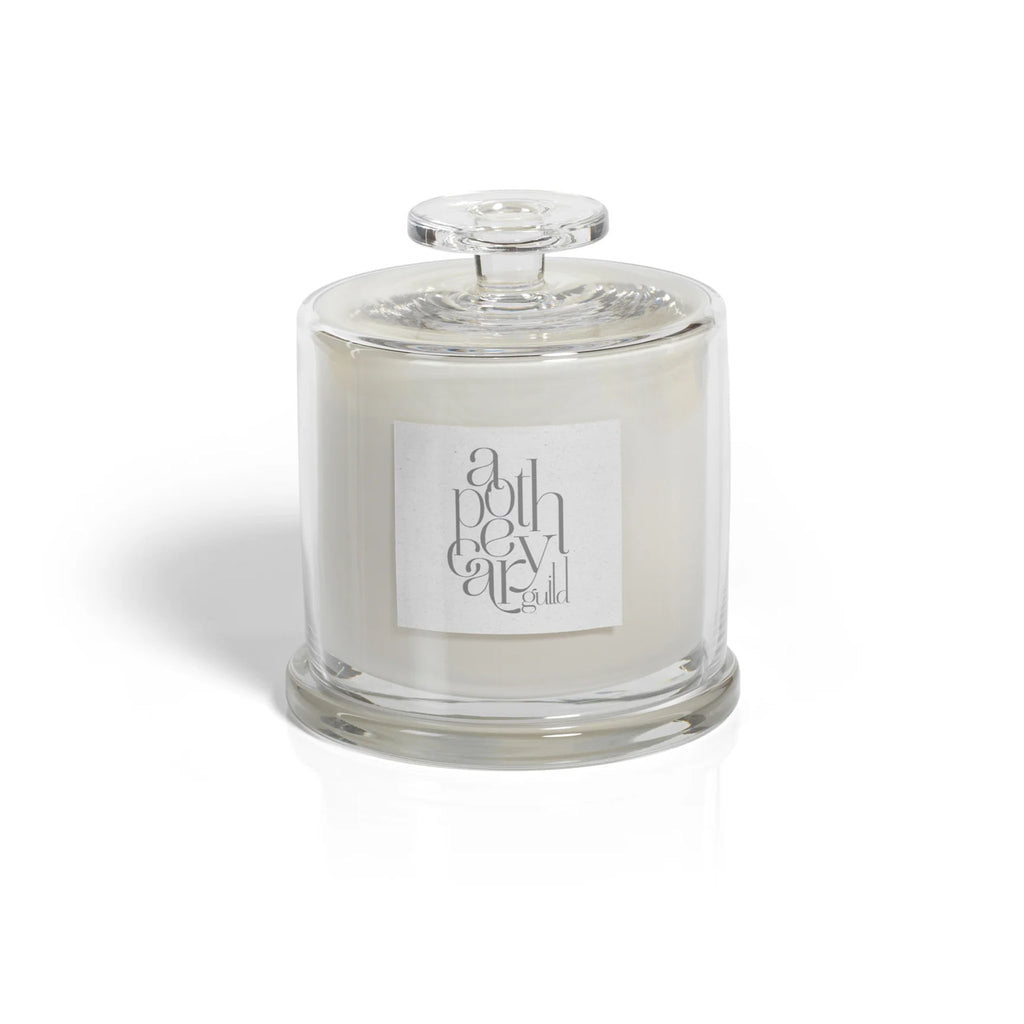 Apothecary guild beach house cloche candle on a white background