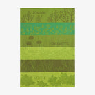 Coucke brand  kitchen towel with herb patterns and names on a green background