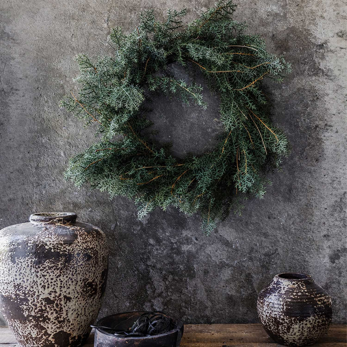 Abigail Ahern Artificial Juniper Wreath on a grey background at Addison West