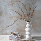 Abigail Ahern Faux Succulent Branch in Coral on a table at Addison West
