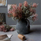 Abigail Ahern Faux Leucospermum Bush in a grey vase at Addison West