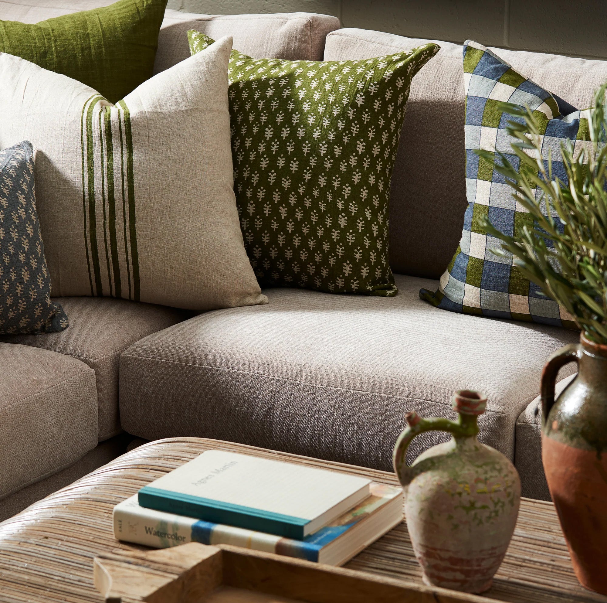 Astra Green 22" Square Pillow on a sofa at Addison West