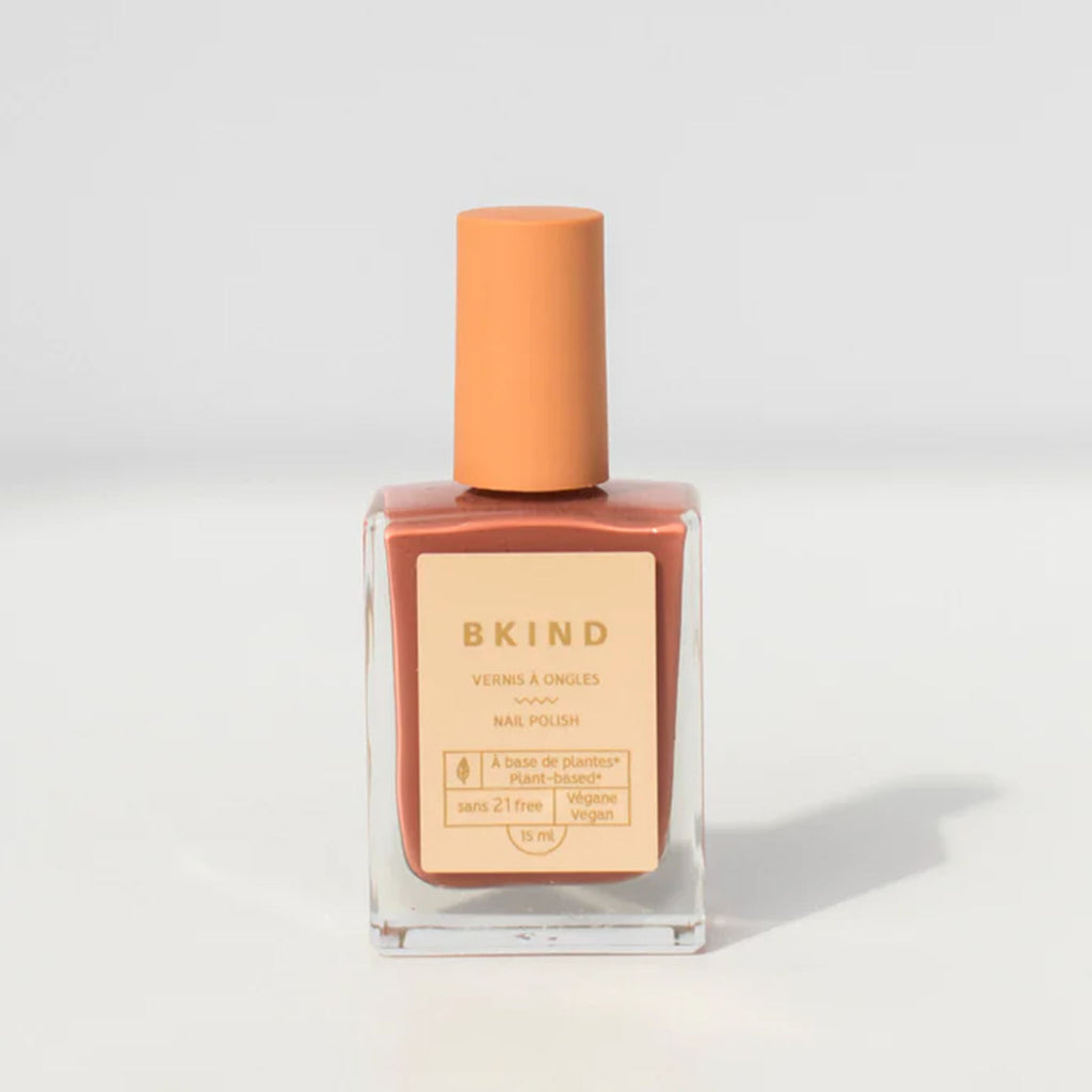 BKIND Nail Polish in Arizona light brown pink bottle on a grey background