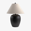 Black surya Bastille table lamp with flared white linen shade on a white background