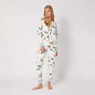 Woman wearing a festive pajama set with a white background
