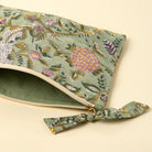 Block Print Pouch in Green on a beige background at Addison West