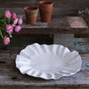 Beatriz Ball Bloom Large Round white melamine Platter on a wood surface with flowers 
