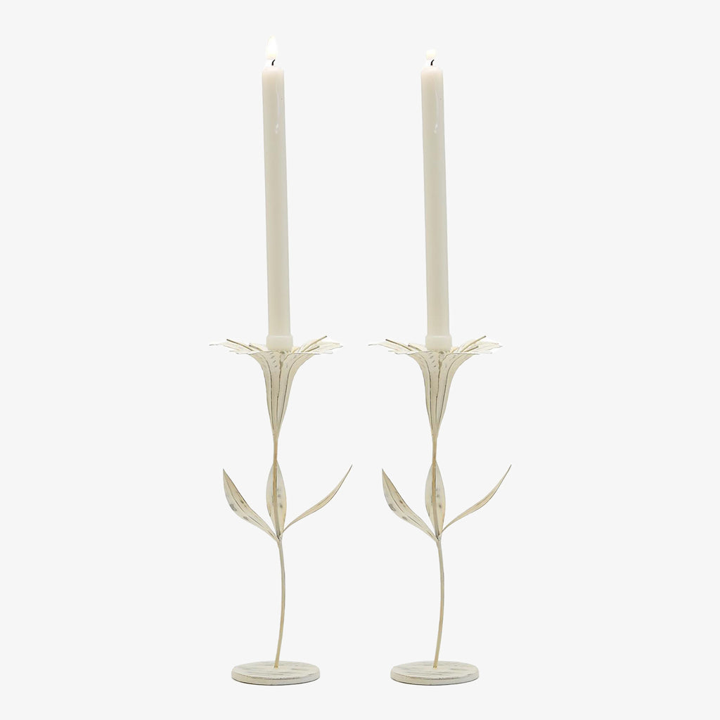 Set of two White metal candle holder with floral petals and leaves on a white background