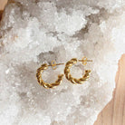 Elli Parr Braided Hoops on a piece of quartz at Addison West
