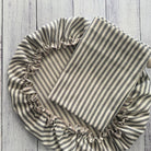 Set of two bag and bowl cover for bread making in Striped fabric with ruffled edges on a wooden surface