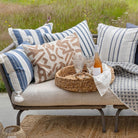 Outdoor pillows on sofa near long grasses