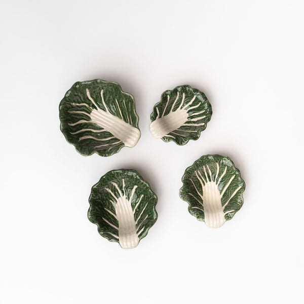 Small set of four cabbage dishes on a white background