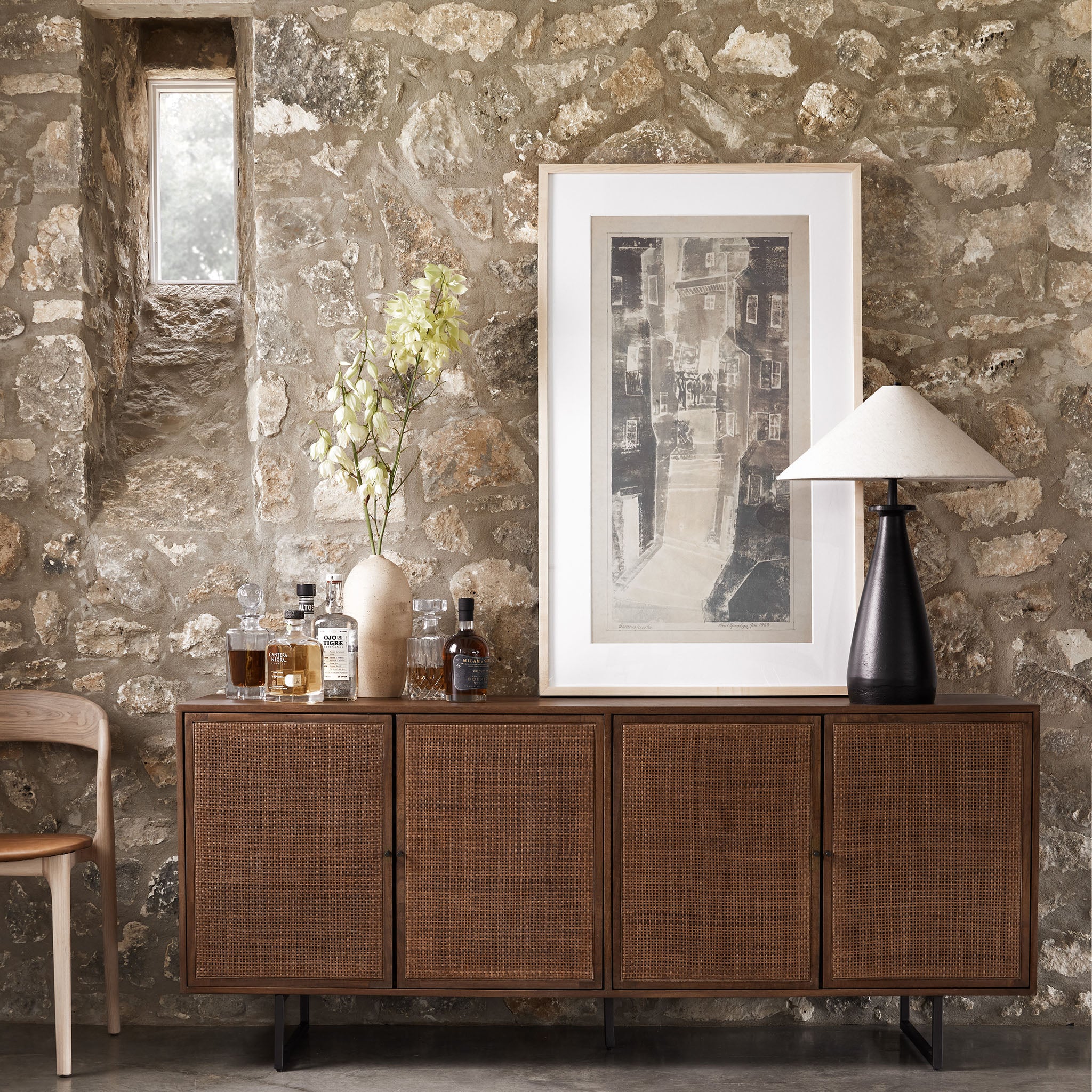Four Hands furniture brand Carmel side board with four cane doors and metal legs. on a white background