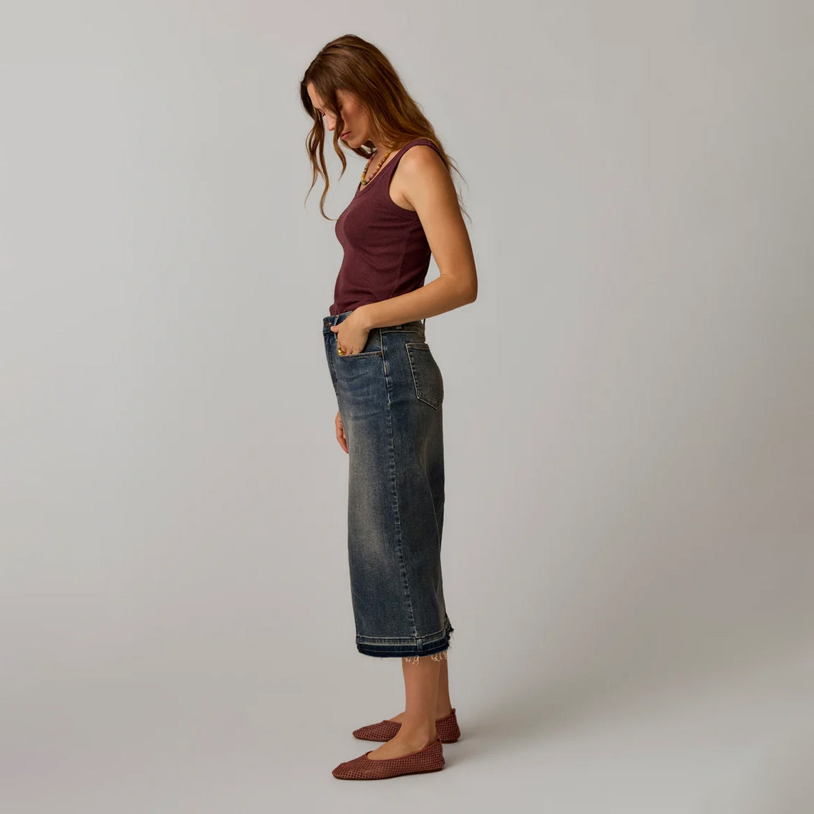 Carve Atlas Denim Skirt in Favorite Fade as shown on female model on plain background.