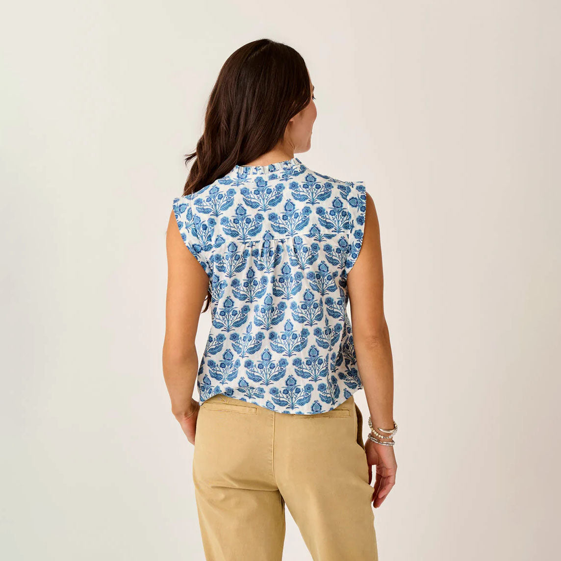 Reagan Top in Folk Floral shown on model on plain background.