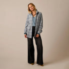 Female model shown wearing the Carve Fairbanks Supersoft Shirt in Blue Mirage Dobby Plaid on plain background.