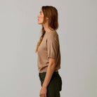 Female model shown wearing Carve Josie Sweater Tee in Dark Barley on plain background.