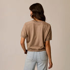 Female model shown wearing Carve Josie Sweater Tee in Dark Barley on plain background.