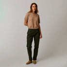 Female model shown wearing Carve Josie Sweater Tee in Dark Barley on plain background.