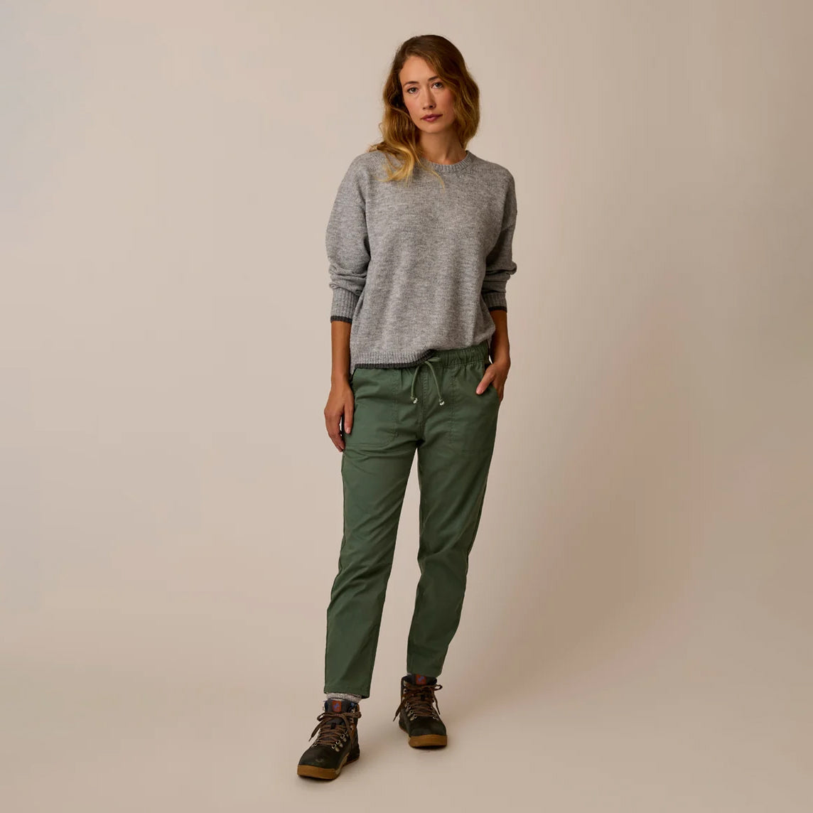 Female model shown wearing the Carve Zoe Twill Pant in Laurel on plain background.